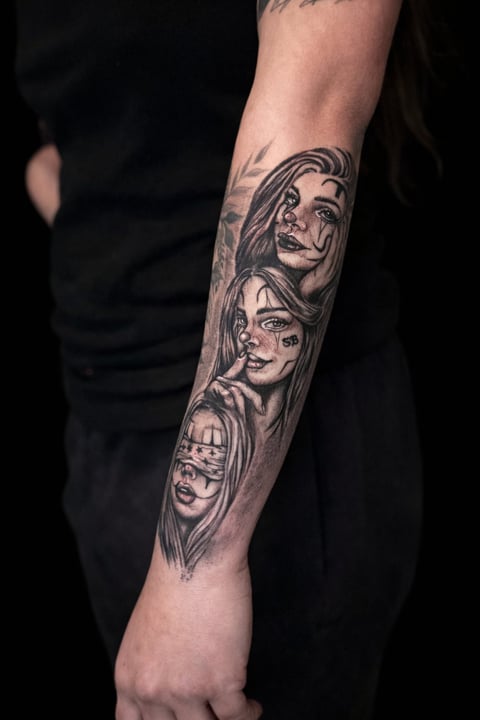 Black and gray tattoo on forearm showing three portrait faces in detailed realistic style